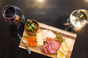 CHarcuterie Board: olives, fruit, cheese, meat, nuts, bread and wine